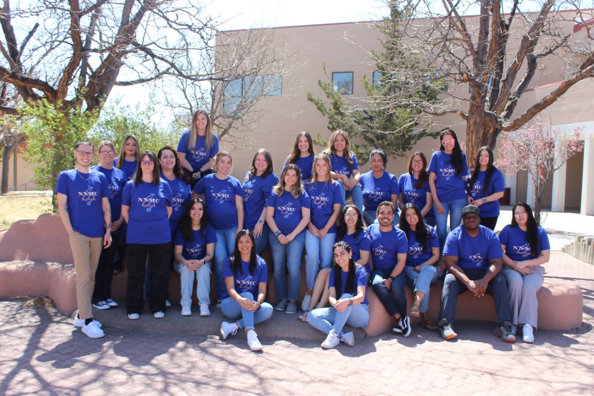 NNMC's 2025 ADN Cohort with the Nursing Building in the background.