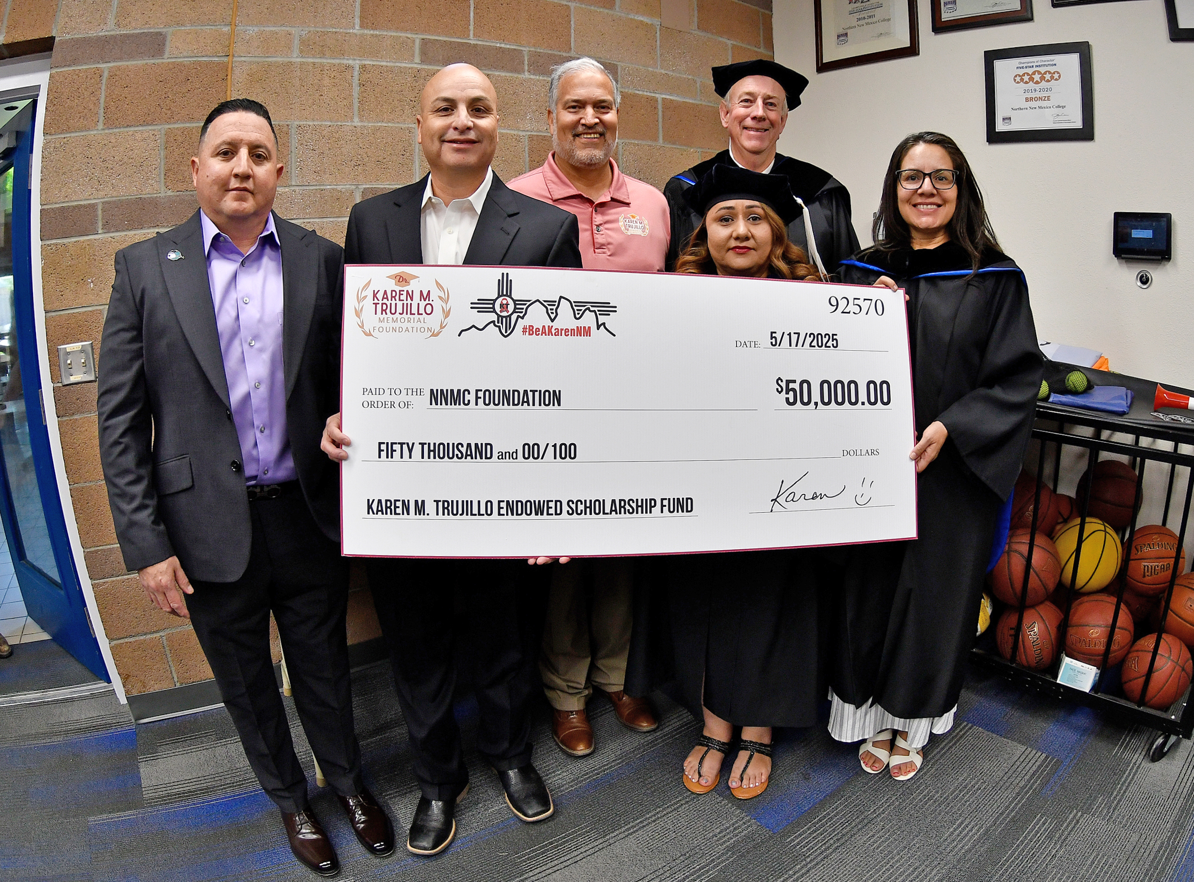 From left: NNMC Regent Ruben Archuleta, NNMC President Hector Balderas, Ben Trujillo, Dr. Karen M Trujillo Memorial Foundation Board President, NNMC Board President Michael Martin, NNMC Regent Dolores Gurule and NNMC Board Vice-President Erica Rita Velarde holding a big check for $50,000